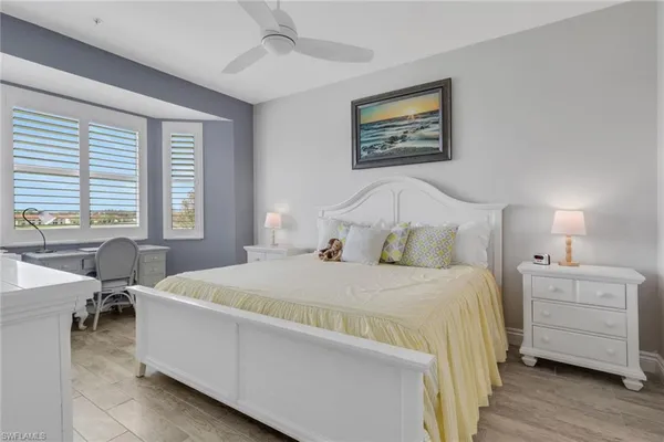 a bedroom with a bed a table and chair