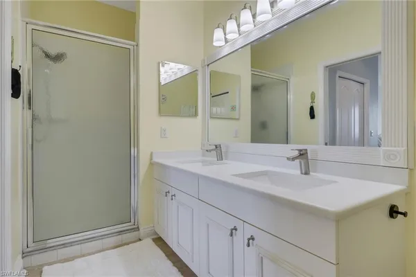 a bathroom with 2 sink and a mirror