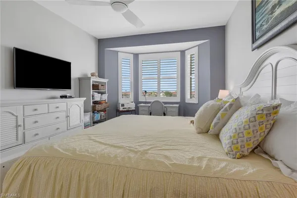 a bedroom with a large bed and a flat screen tv