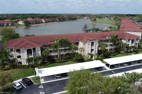 an aerial view of house with yard swimming pool and lake view
