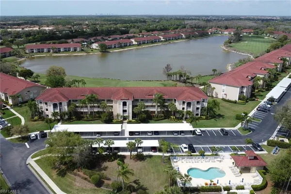 an aerial view of house with yard and lake view