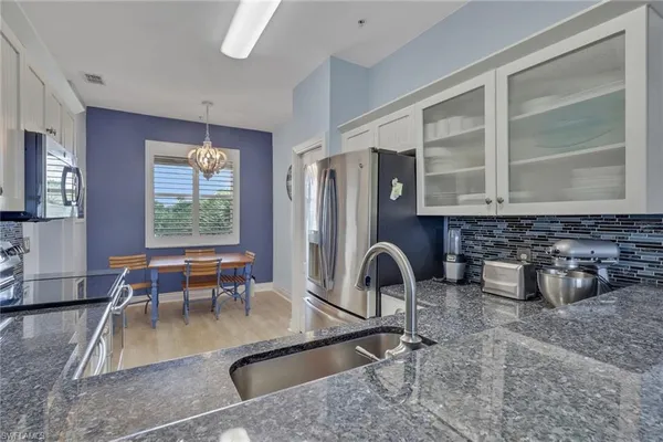a dining room with furniture and a floor to ceiling window
