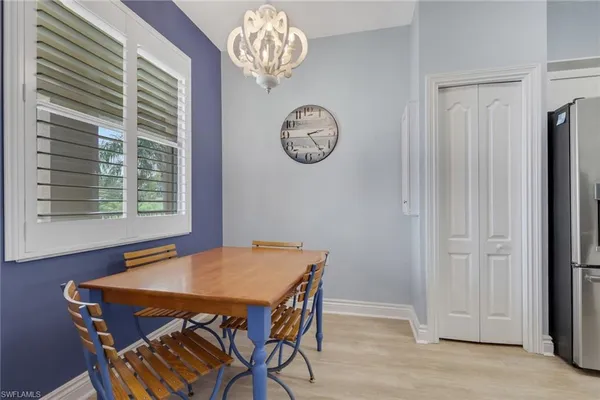 a view of a dining room with furniture and a window