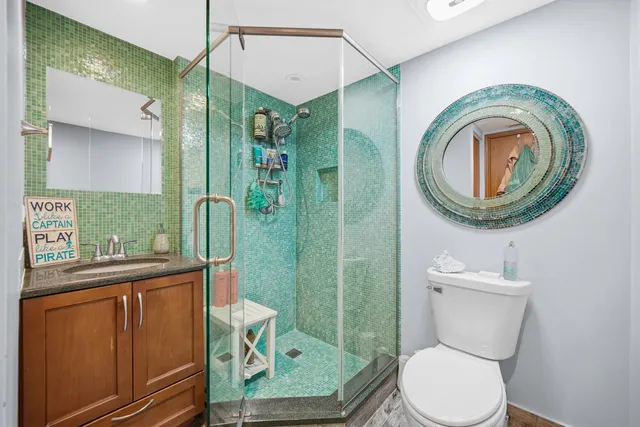 a bathroom with a toilet a sink and mirror