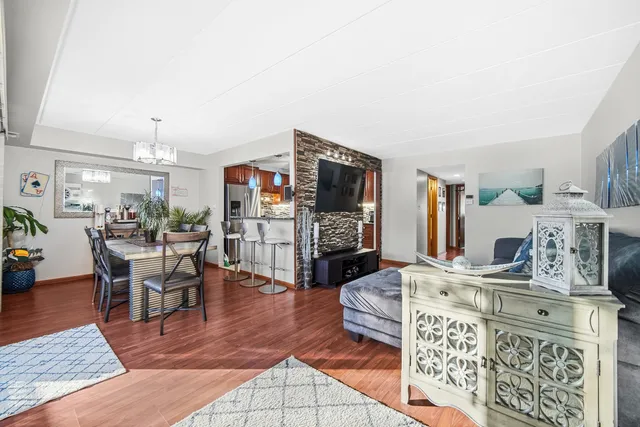 a living room with furniture a flat screen tv and a table