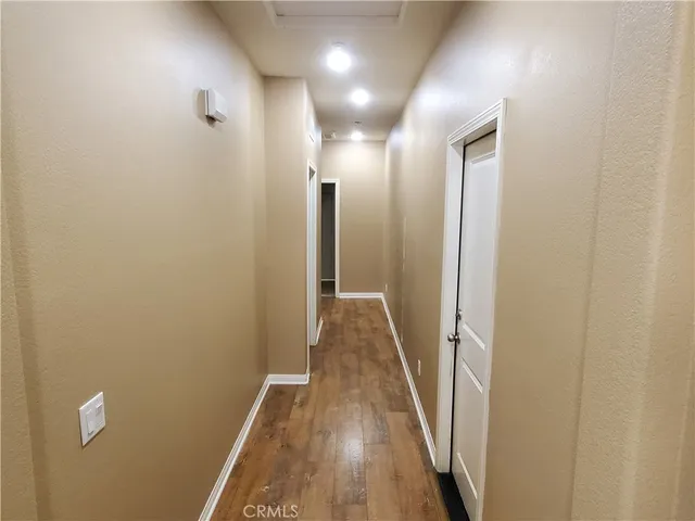 a view of hallway with wooden floor