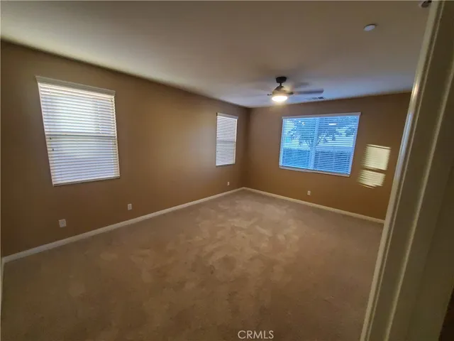 an empty room with windows and closet
