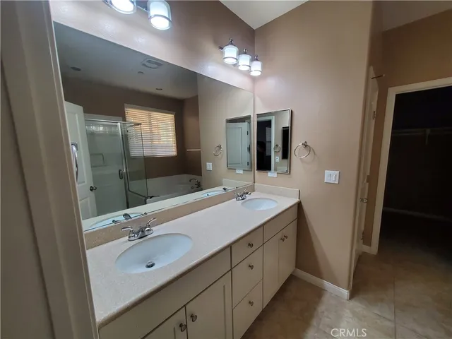 a bathroom with a double vanity sink and a mirror