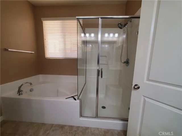 a white bath tub sitting next to a shower