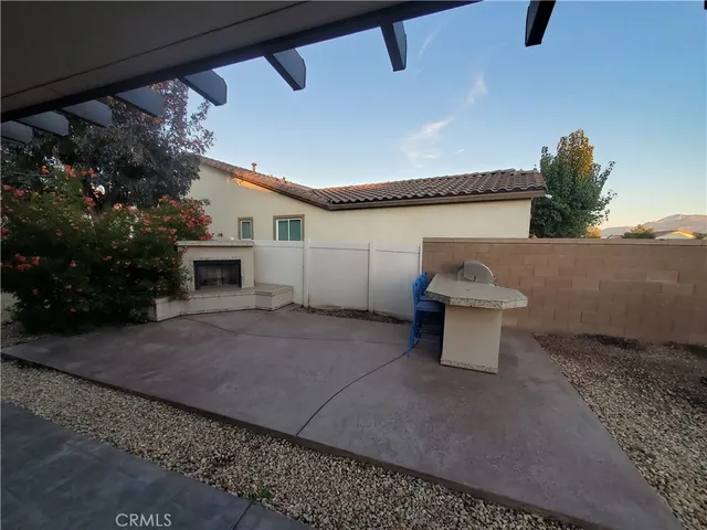 a view of a patio with table and chairs potted plants