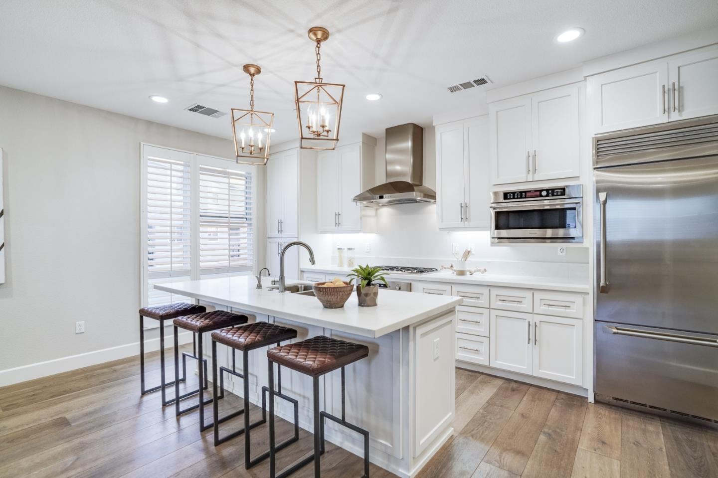 416 Neves Road San Mateo, CA 94403 - Photo 15 of 40 a kitchen with stainless steel appliances granite countertop a sink a stove a refrigerator and island with wooden floor