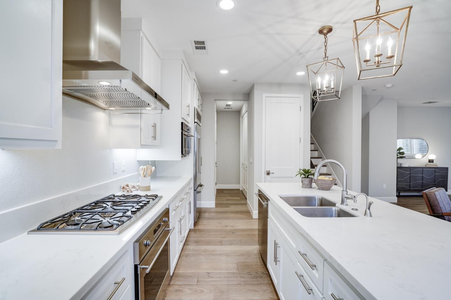 416 Neves Road San Mateo, CA 94403 - Photo 17 of 40 a large kitchen with kitchen island a large counter space a sink appliances and cabinets