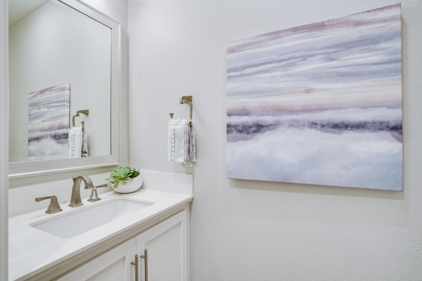 416 Neves Road San Mateo, CA 94403 - Photo 21 of 40 a bathroom with a granite countertop sink and a mirror