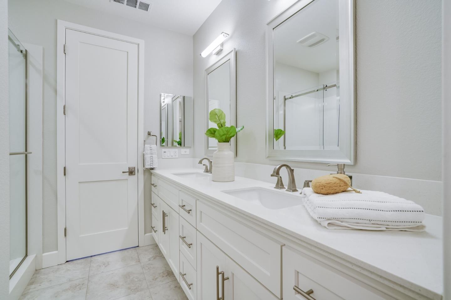 416 Neves Road San Mateo, CA 94403 - Photo 27 of 40 a bathroom with a double vanity sink and a mirror