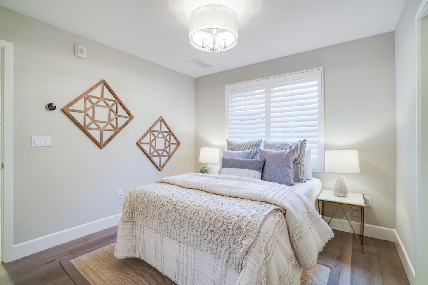 416 Neves Road San Mateo, CA 94403 - Photo 7 of 40 a bedroom with a bed and wooden floor