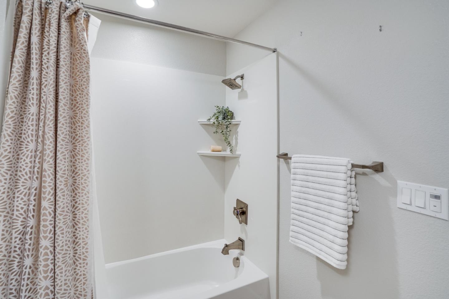 416 Neves Road San Mateo, CA 94403 - Photo 10 of 40 a bathroom with a shower and a bathtub