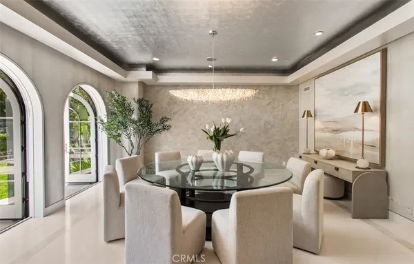 a living room with furniture a flat screen tv and kitchen view