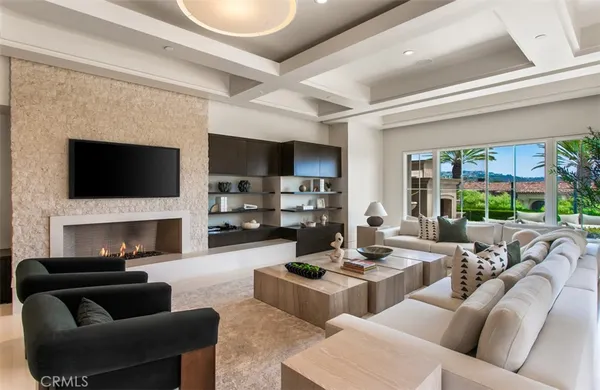 a living room with patio fireplace furniture and a flat screen tv