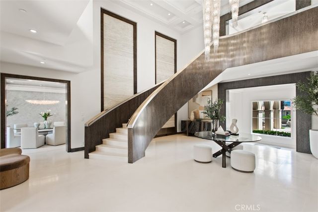 a living room with furniture potted plant and a large window
