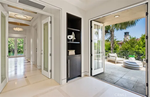 a living room with furniture kitchen view and a large window