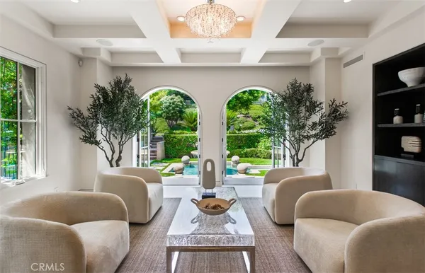 a living room with furniture a fireplace and a large window