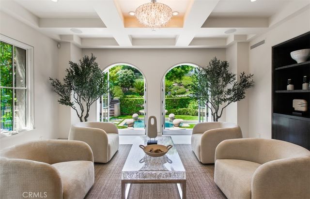 a living room with furniture a fireplace and a large window