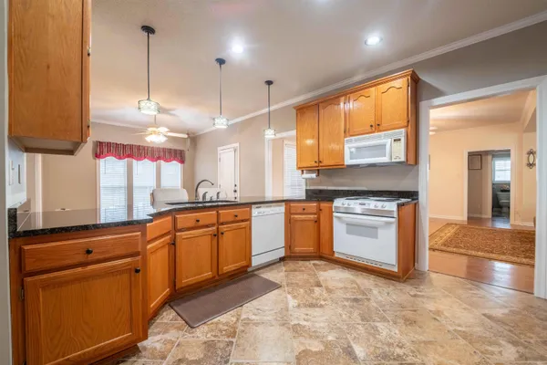 a kitchen with stainless steel appliances granite countertop a sink and cabinets