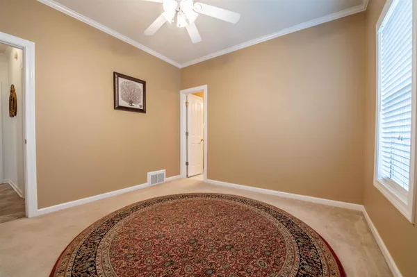 a dining room with furniture and a floor to ceiling window
