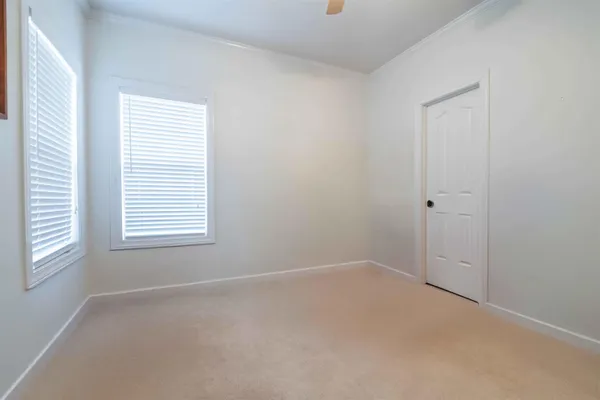 an empty room with stairs and white walls