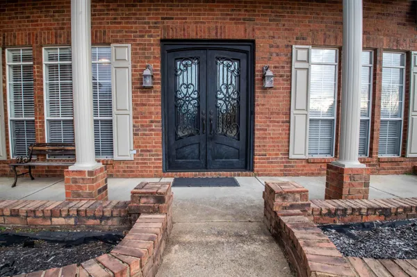 a front view of a house with outdoor seating