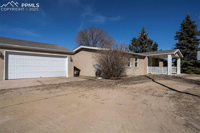 5860 Curtis Road Peyton, CO 80831 - Photo 1 of 28 Ranch-style house with stucco siding and a porch