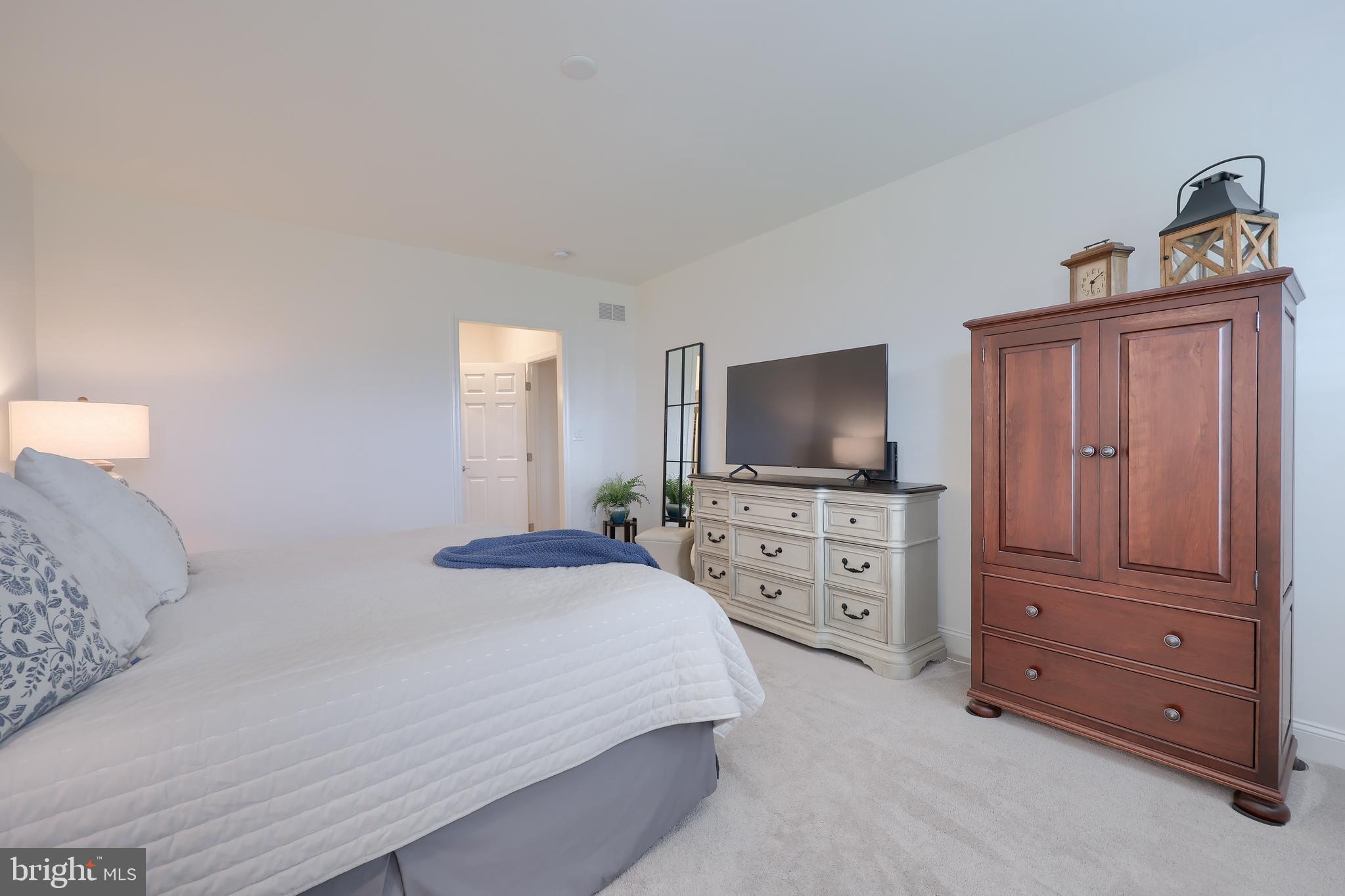 373 Autumn Harvest Lane Lititz, PA 17543 - Photo 11 of 28 a bedroom with a bed and a flat screen tv in it