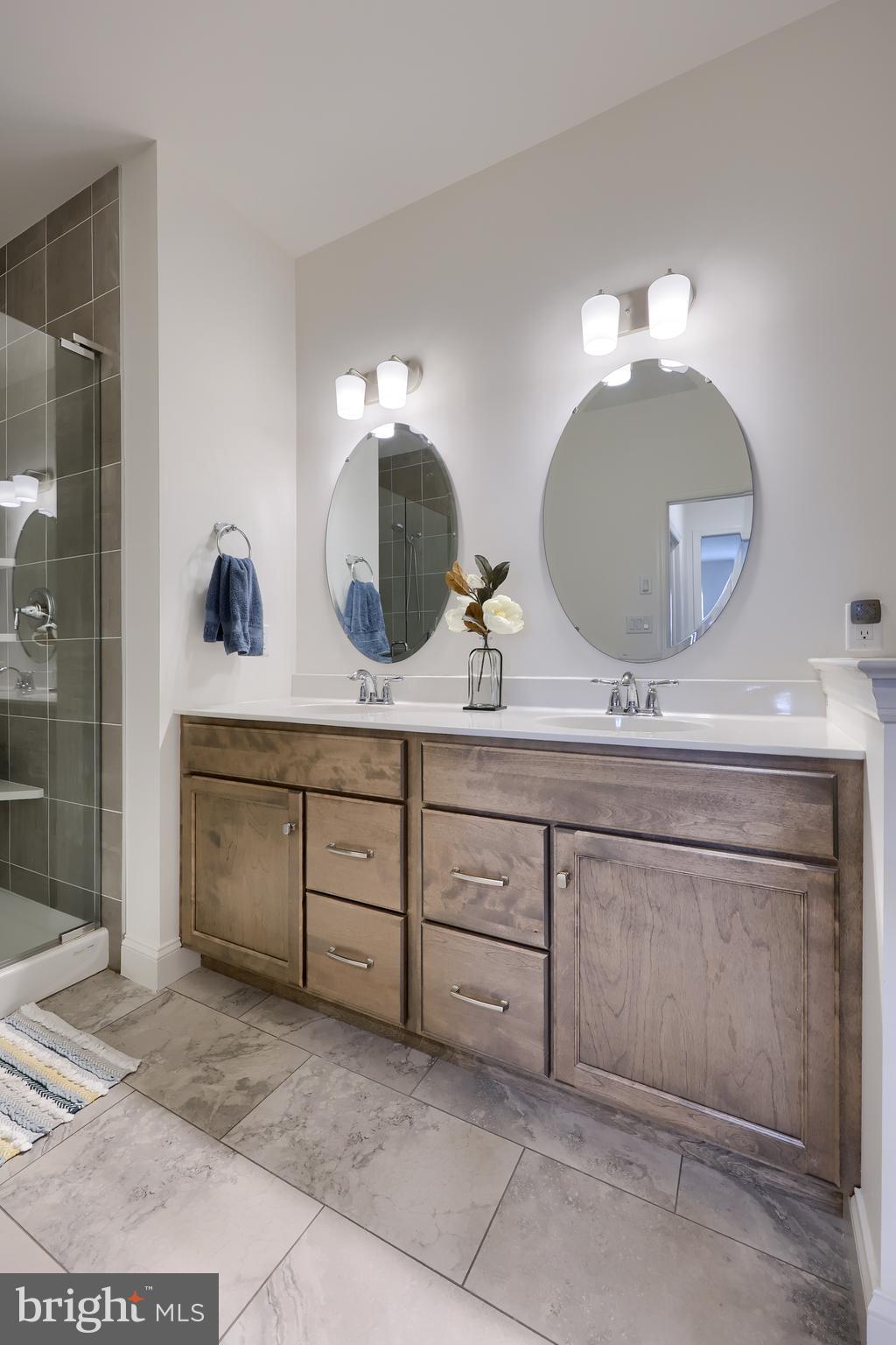 373 Autumn Harvest Lane Lititz, PA 17543 - Photo 17 of 28 a bathroom with a double vanity sink and a mirror