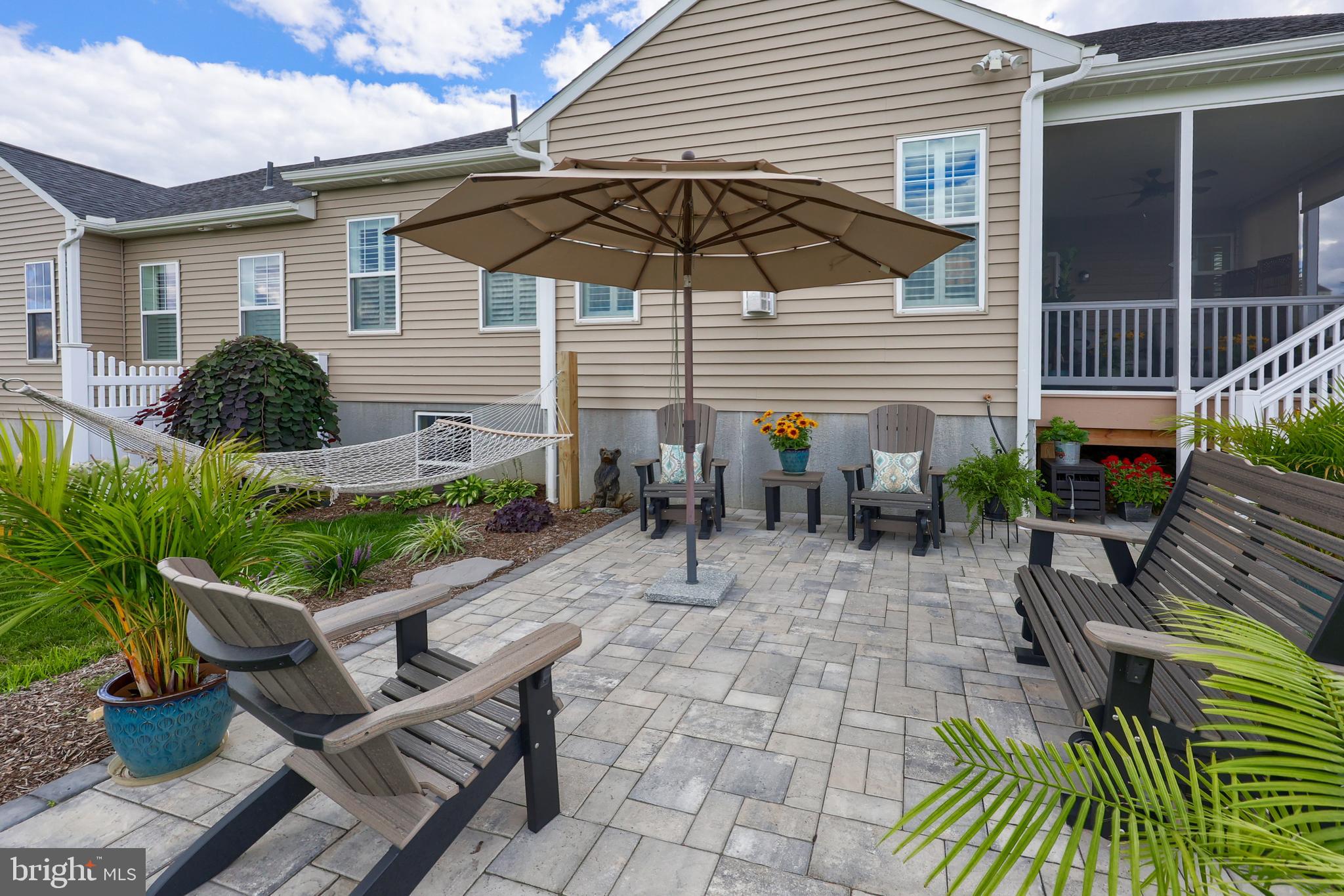 373 Autumn Harvest Lane Lititz, PA 17543 - Photo 21 of 28 a view of a patio with table and chairs under an umbrella