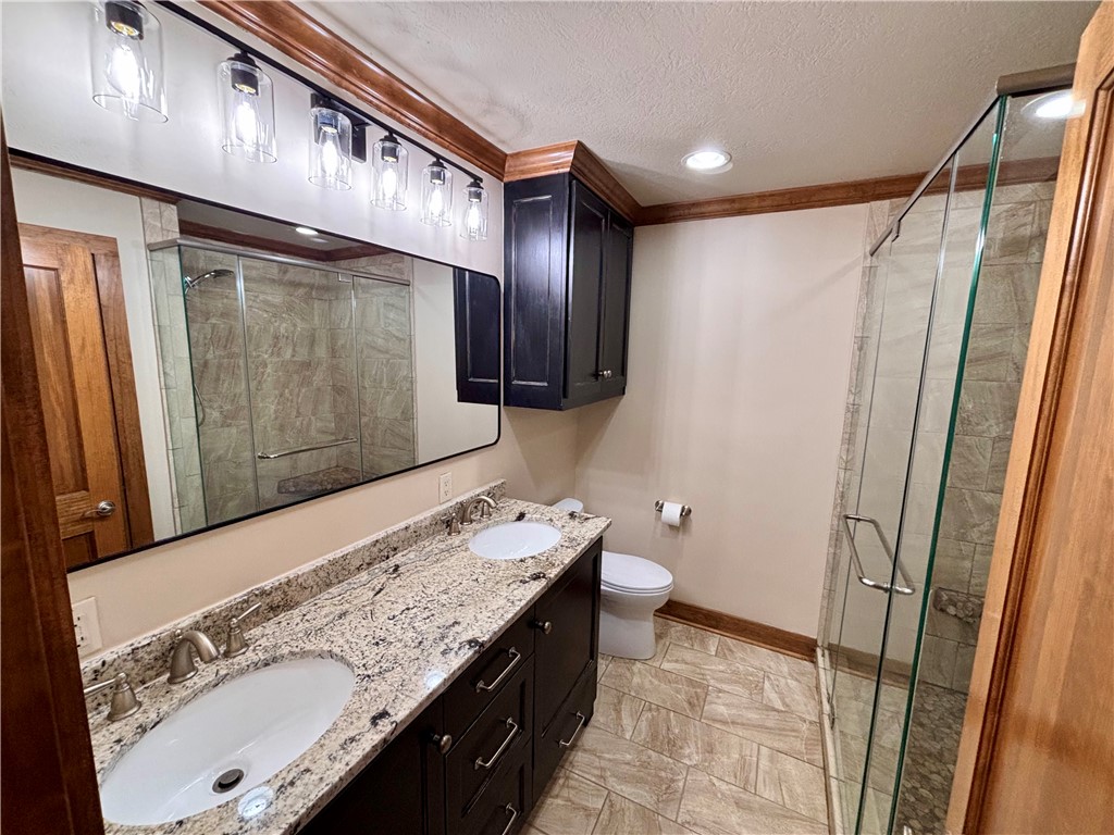 2302 Quail Run College Station, TX 77845 - Photo 15 of 49 a bathroom with a sink a toilet and a shower