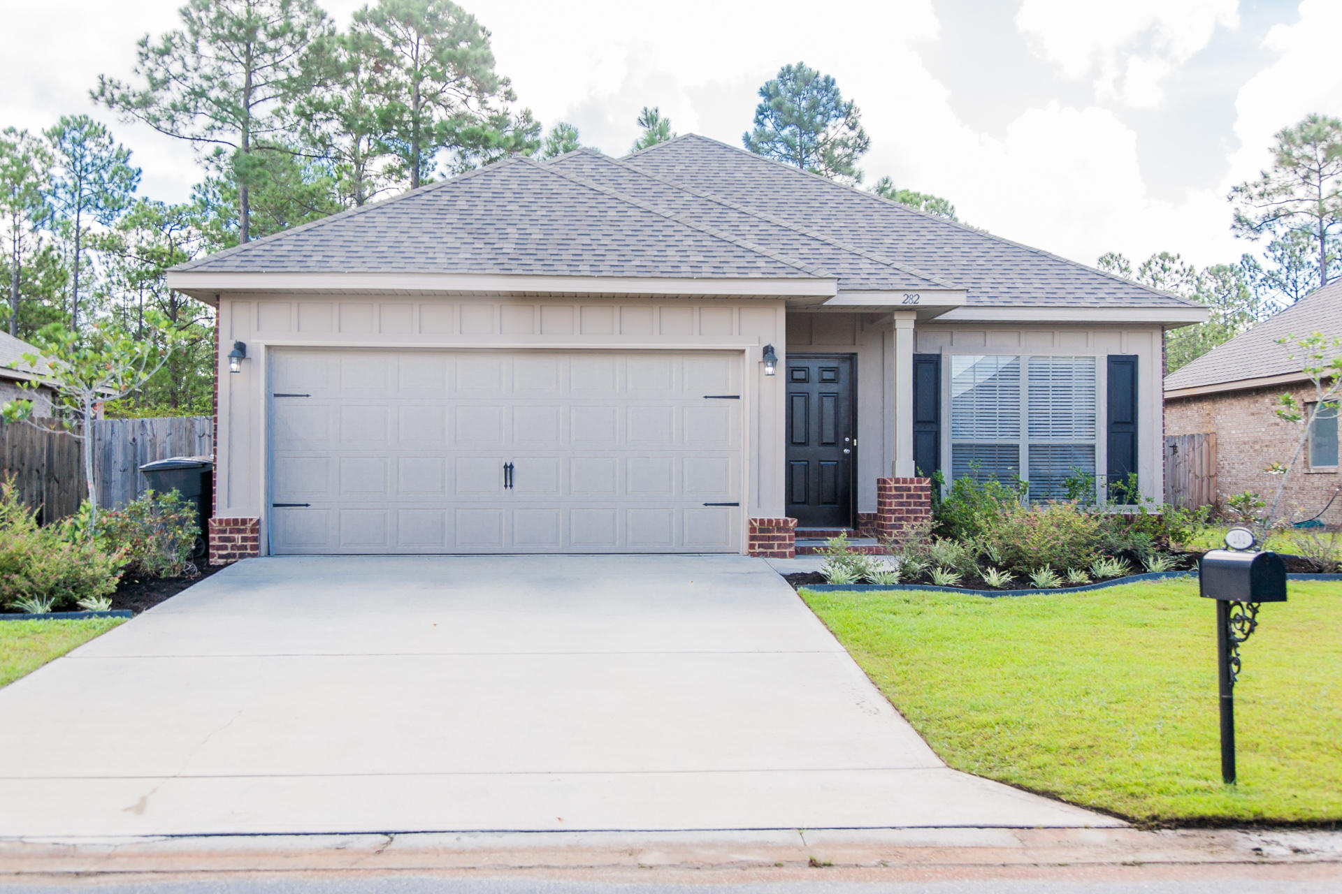 282 Whispering Lake Drive Santa Rosa Beach, FL 32459 - Photo 1 of 18 a front view of a house with a yard and garage