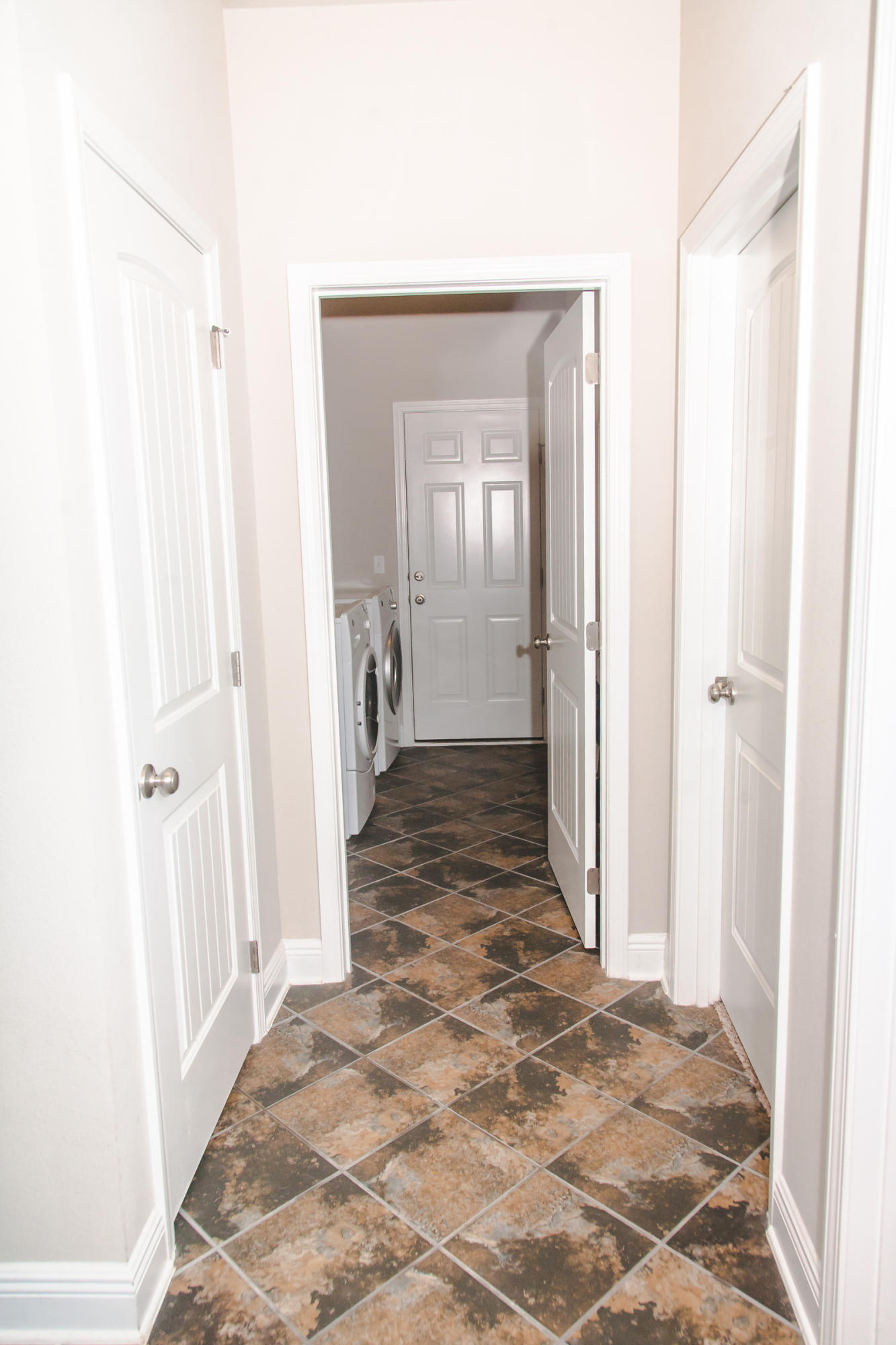 282 Whispering Lake Drive Santa Rosa Beach, FL 32459 - Photo 17 of 18 a view of a hallway with a livingroom and a bathroom space