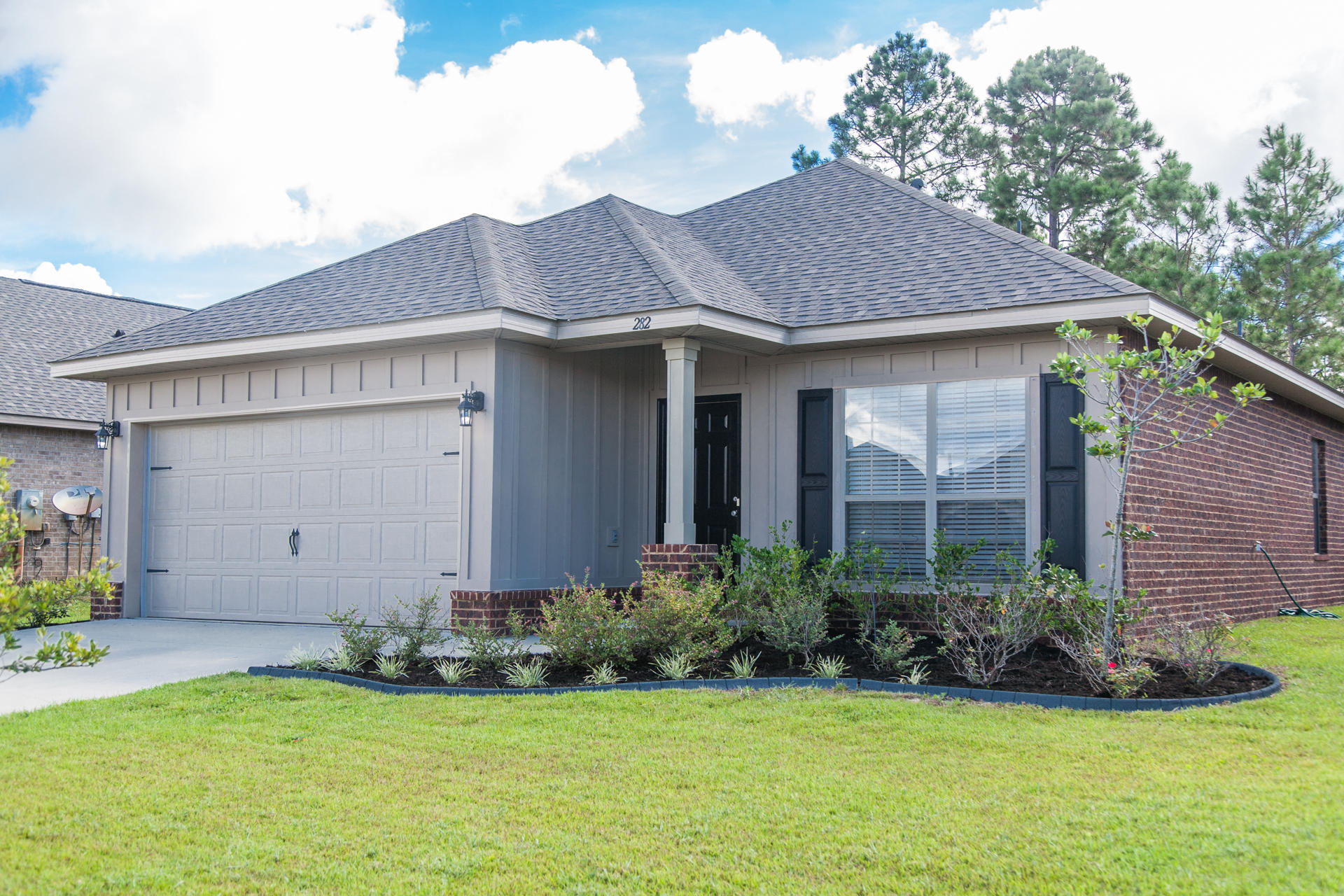 282 Whispering Lake Drive Santa Rosa Beach, FL 32459 - Photo 2 of 18 a view of a house with garden
