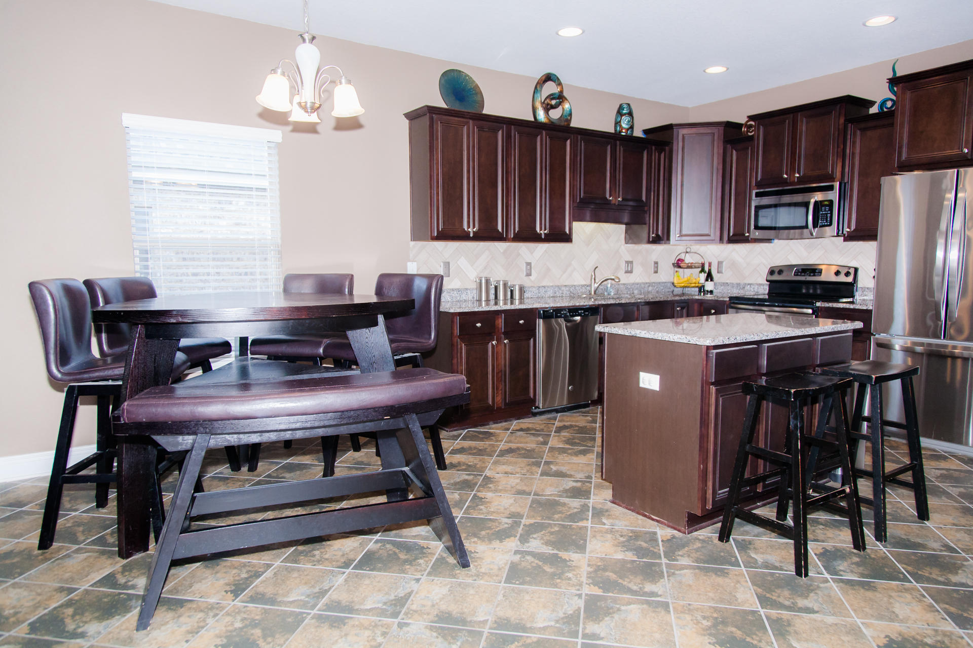 282 Whispering Lake Drive Santa Rosa Beach, FL 32459 - Photo 6 of 18 a kitchen with kitchen island a dining table and chairs