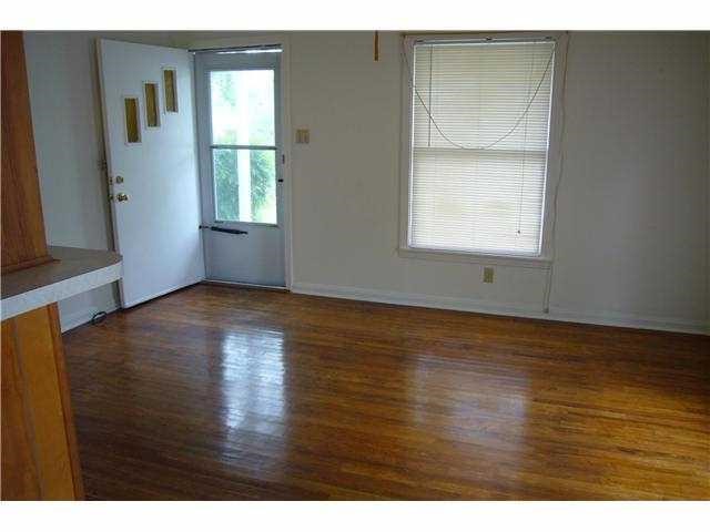 1708 Madison Avenue Austin, TX 78757 - Photo 2 of 20 a view of an empty room with wooden floor and a window