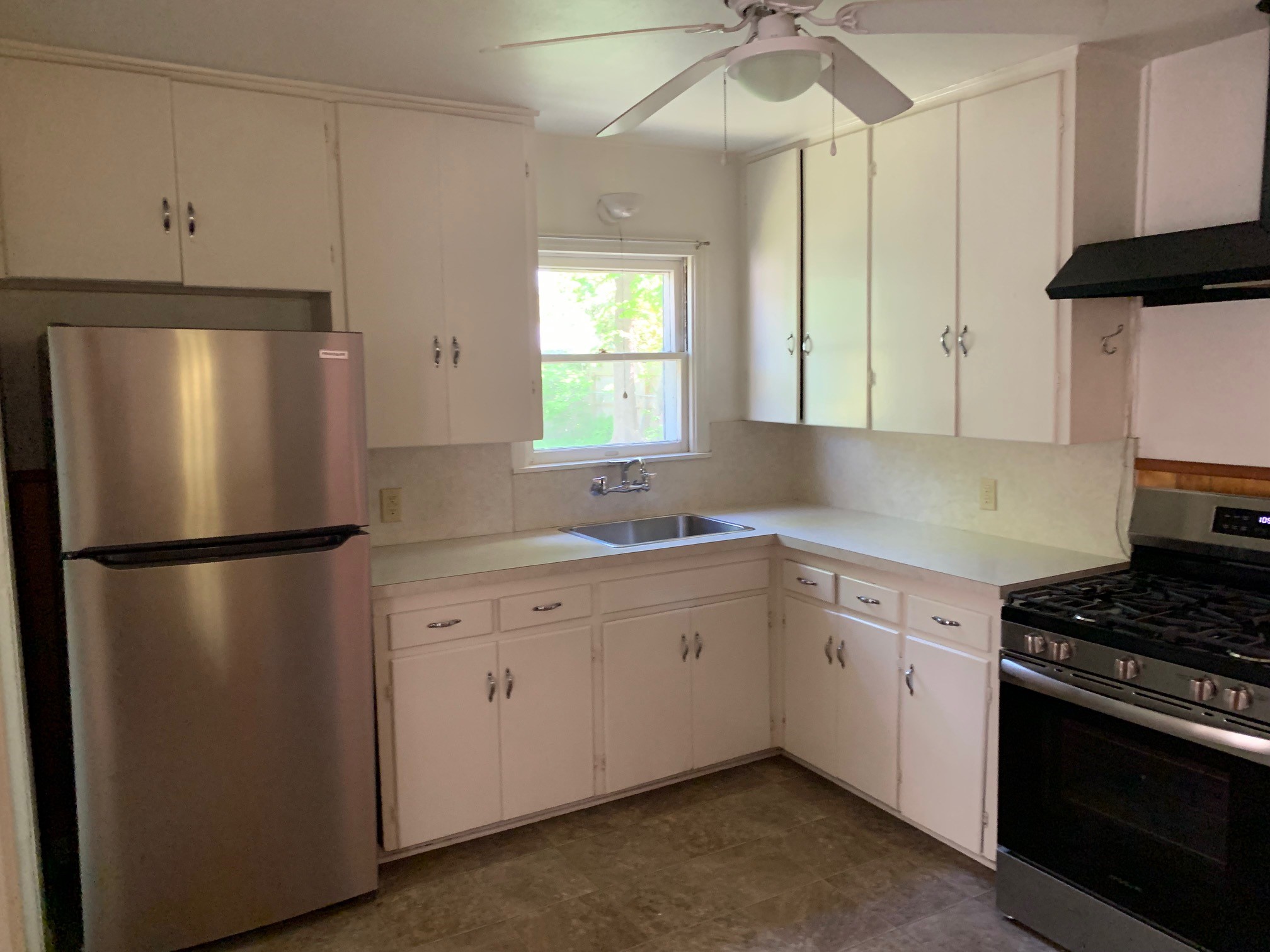 1708 Madison Avenue Austin, TX 78757 - Photo 3 of 20 a kitchen with a refrigerator sink and cabinets