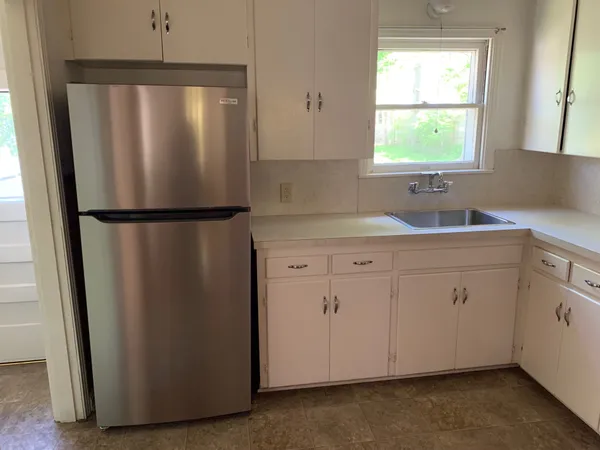 a white refrigerator freezer sitting in a kitchen