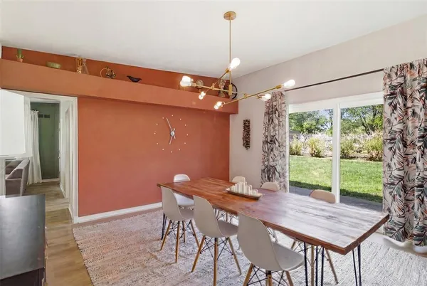 a view of a dining room with furniture window and wooden floor