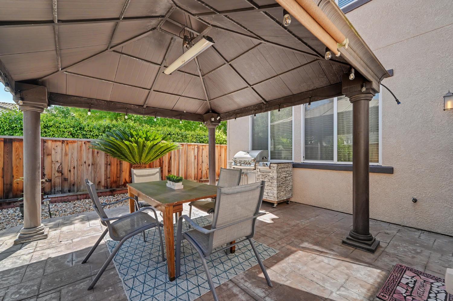 1223 East Springer Drive Turlock, CA 95382 - Photo 45 of 48 a view of a patio with table and chairs under an umbrella