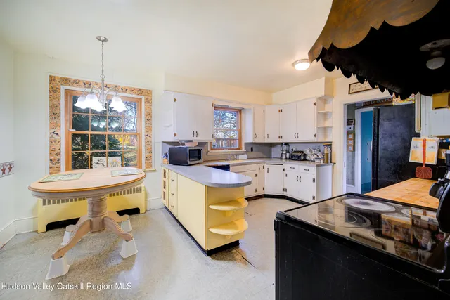 a kitchen with a sink appliances and cabinets