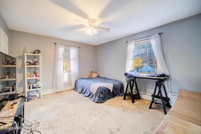 a bedroom with furniture and a window