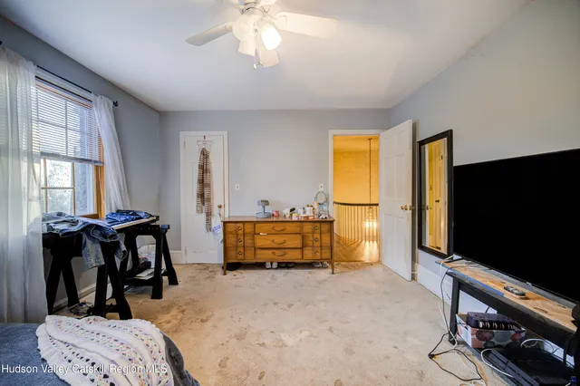a bedroom with furniture and a window