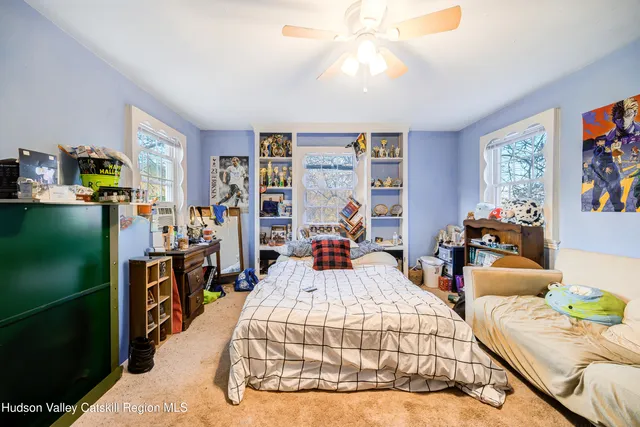 a bed room with furniture and a flat screen tv