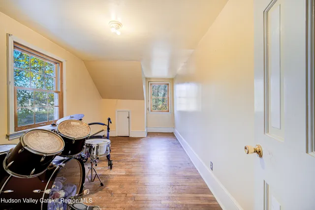 a view of a hallway with furniture and wooden floor