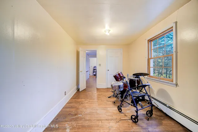 a view of a room with wooden floor and furniture